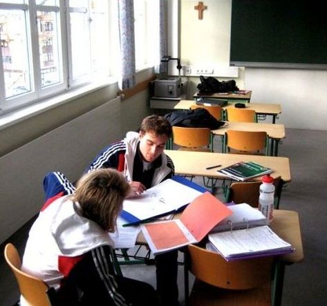 Sam Naef tutoring a student in a classroom